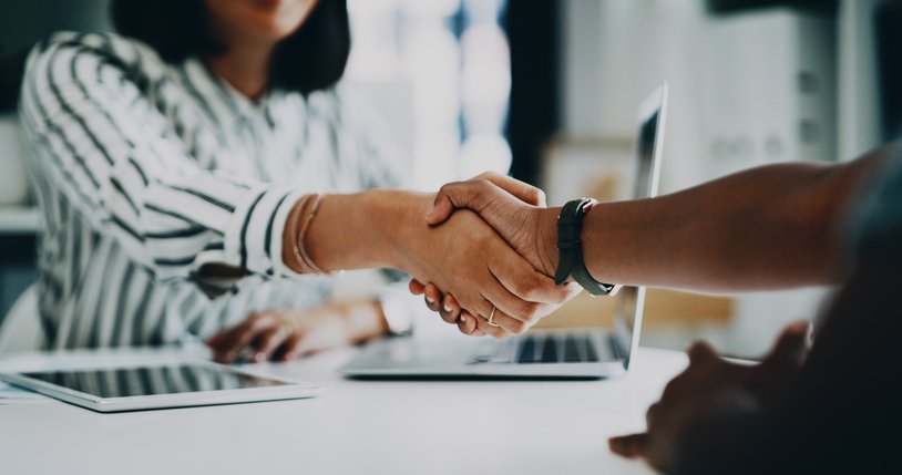Closeup shot of two unrecognisable businesspeople shaking hands in an office